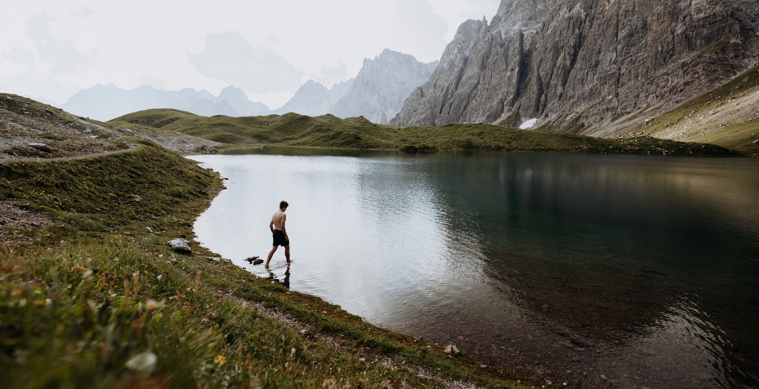 Man by a mountain lake
